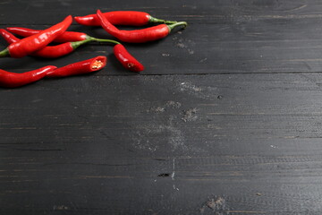Fresh Red Chili Peppers on Black Wooden Background