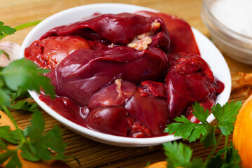Raw chicken liver ready for cooking on cutting board