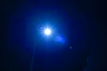  Lens Flare.Light reflections in the dark. blue Light of a lantern in the night.Silhouette of a man...