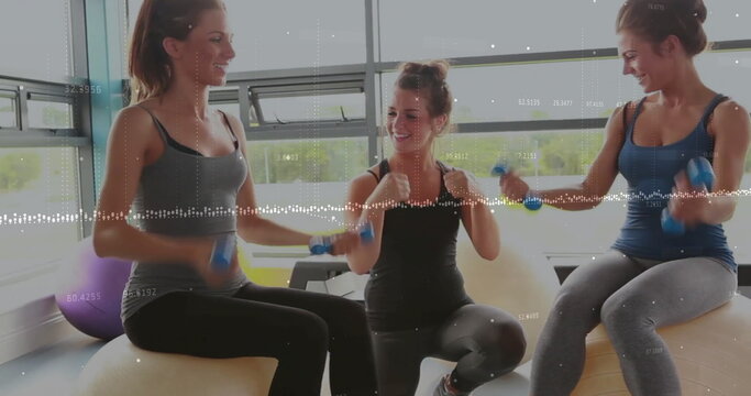Image of financial data processing over diverse female friends exercising at gym - Powered by Adobe