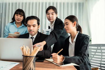 Diverse of business people from various ethnic group working in modern office environment. Productive and multi ethnic office workers engage in discussion for strategic business marketing. Habiliment