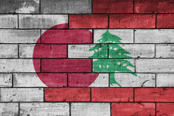 colourful painted big flag of japan and flag of lebanon on a massive old brick wall background....