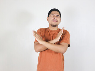 Serious-looking concerned asian male showing forbid gesture, making cross sign to stop someone,...