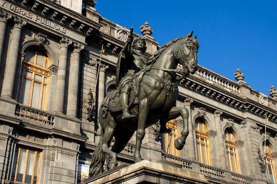 Mexico City, Mexico  November 12, 2024: Equestrian statue of King Charles IV of Spain, also known as El Caballito, and Former Palace of the Secretariat of Communications and Public Works.