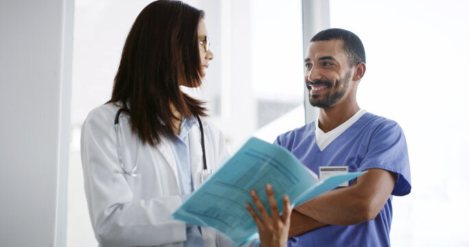 Healthcare, doctors and paper in hospital for discussion, patient folder or medicine schedule. Woman, man nurse and document in clinic for medical report, information results and surgery feedback