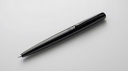 A sleek black pen next to a notebook
