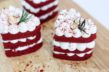 Close-up cake, cream cheese frosting,and raspberries red velvet cake on a white table.