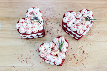 Close-up cake, cream cheese frosting,and raspberries red velvet cake on a white table.