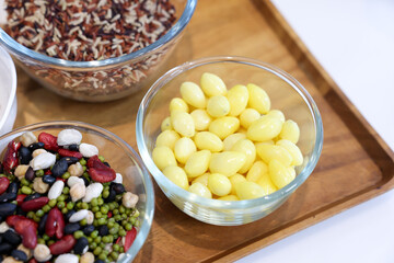 Different types of cereals, seeds and legumes on wooden table, flat lay