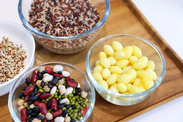 Different types of cereals, seeds and legumes on wooden table, flat lay
