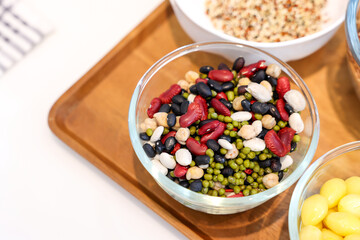 Different types of cereals, seeds and legumes on wooden table, flat lay