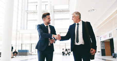 Business, people and handshake in lobby for welcome, greeting or CEO respect. Corporate men, smile...