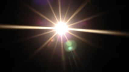 Bright Starburst Lens Flare on Black Background