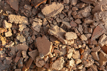Top view of construction rubble and broken bricks on the ground. Construction waste management...