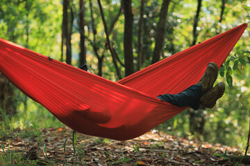 Relaxing in hammock in tropical forest
