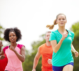 People, fitness or running with friends in nature for outdoor workout, exercise or physical...