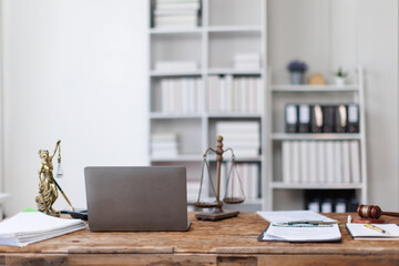 Laptop Computer, notebook, Law, legal services, advice, justice and law concept and eyeglasses sitting on a desk in a large open plan office space after working hours	