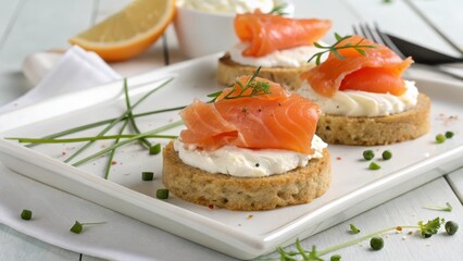 Elegant Smoked Salmon Canap?s with Cream Cheese and Fresh Herbs on a White Plate