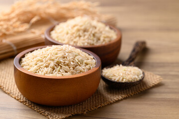 Organic Jasmine brown rice seed in wooden bowl with spoon, Thai Rice