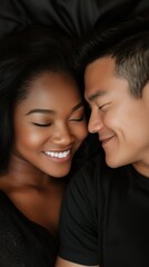 Mixed couple, black woman and asian man smiling at each other in bed. Vertical photography (9:16)