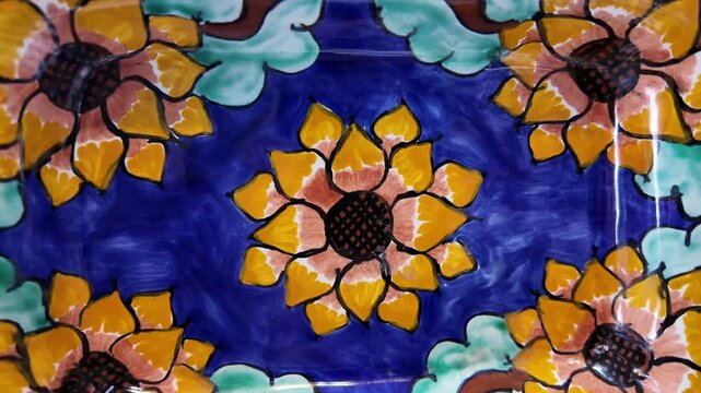 A blue and yellow plate with flowers on it