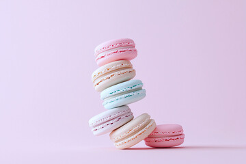 Close up of macarons in a spiral pattern, set against a soft pastel background for an elegant touch