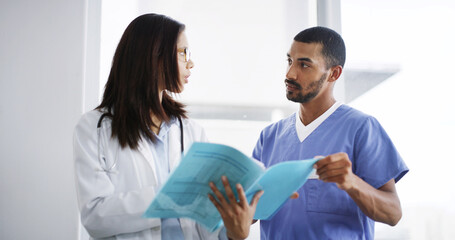 Fototapeta premium Doctor, woman and man with report, discussion and teamwork for medical solution at hospital. People. documents and confused with problem solving, review and research with info for bird flu at clinic