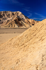 A mountain range is in the background of a desert