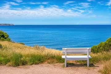 Tranquil Coastal View with White Bench on Scenic Clifftop Path