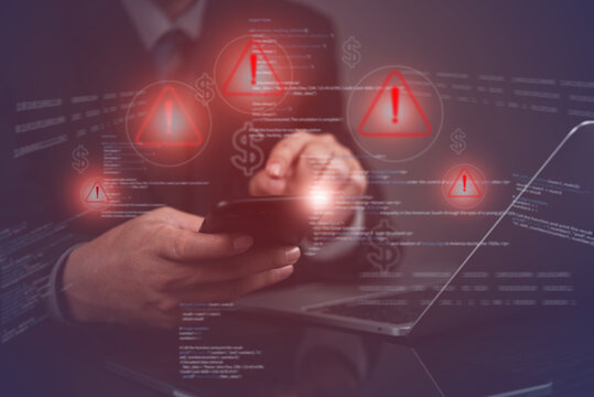businessman hand using a smartphone with warning and financial risk data. cybersecurity hacking threats, fraud alerts, online transactions scams, financial protection strategies.business management.