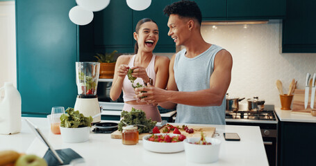 Laugh, ingredients and couple with smoothie in kitchen for diet, health and wellness together. Love, happy and young woman and man with vegetables and fruit for nutrition juice breakfast in home.