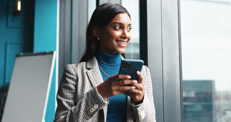 Thinking, window and woman with smartphone, creative and employee with ideas for engagement and...