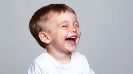 Happy Toddler Boy Laughing in Studio Portrait
