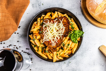 Crispy breaded chicken served over penne pasta tossed in a spicy arrabbiata sauce, topped with fresh basil and shredded mozzarella cheese.