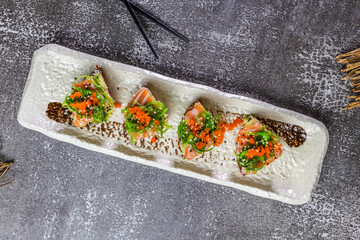 Gourmet sushi bites with salmon avocado and tobiko
