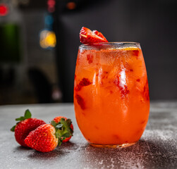 Strawberry cocktail with citrus garnish on ice
