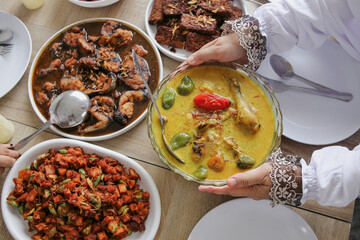Close-up Top View Of Hand Serving Opor Ayam, Special Dish From Indonesia To Celebrating Eid With Family 