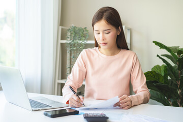 Deduction planning, debt asian young woman calculating money balance of finance from bill and...