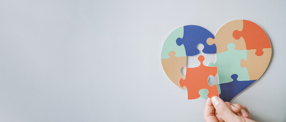 hands holding jigsaw puzzle heart shape, Autism awareness,Autism spectrum disorder family support...