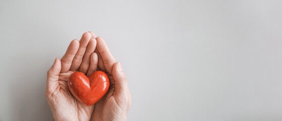 hands holding red heart, heart health insurance, charity volunteer donation, CSR responsibility,...
