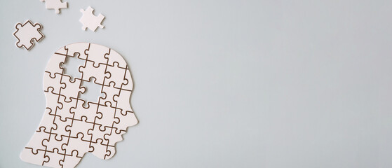 Hands holding brain with puzzle paper cutout, autism, dementia, Epilepsy and Alzheimer awareness,...