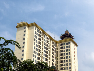 Architectural contrast: modern building with clean lines juxtaposed against a traditional pagoda-inspired rooftop design.