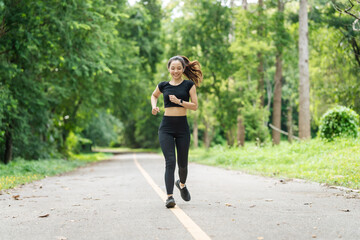 A woman in sportswear running in the park, enjoying fresh air, engaging in outdoor activities to maintain a healthy lifestyle, boosting cardiovascular health, and feeling happy and energetic