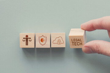 Hand holding wooden block with legal tech icons, legal technology business concept