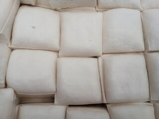 Cut tofu cubes on a white background close-up