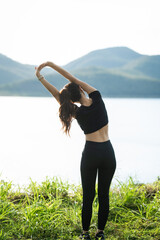 A woman in sportswear running in the park, enjoying fresh air, engaging in outdoor activities to maintain a healthy lifestyle, boosting cardiovascular health, and feeling happy and energetic