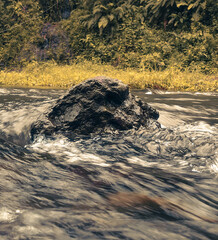Black Rock in the Middle of a River
