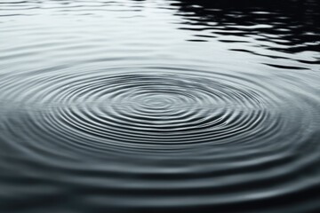 Ripple effects on a still water surface, creating gentle waves and smooth, circular patterns with a sense of calm and tranquility