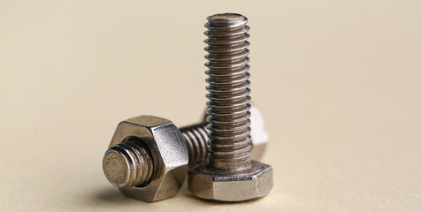 Tap bolts with nut on color background