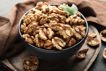 Fresh ripe walnuts in bowl on table, closeup